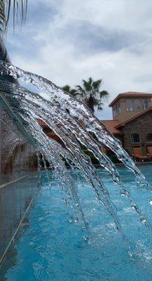 Under the waterfall at the pool