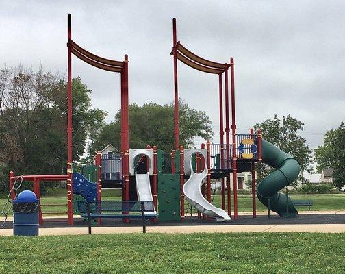 The playground has a rubber surface for safety.