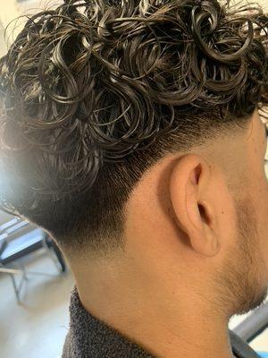 Fade haircut with a perm service.