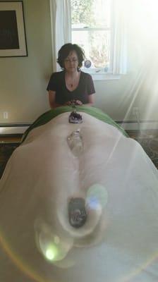 Reiki session incorporating amethyst and clear quartz crystals.