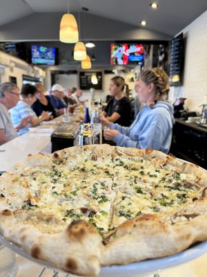 TRUFFLE MUSHROOM 27 shiitake mushrooms, goat cheese, mozzarella, kashmir chili oil, truffle honey, scallions