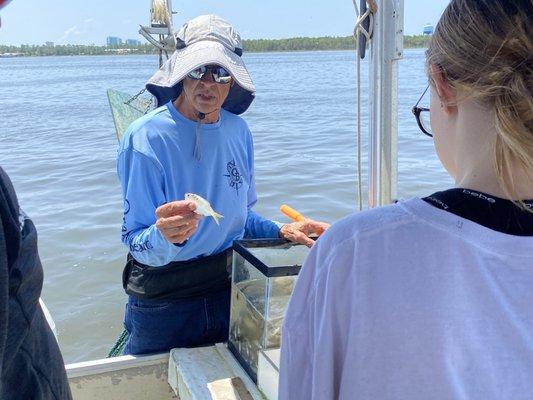 Showing us the different types of fish we caught