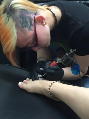 Taylor working on daughter's first tattoo