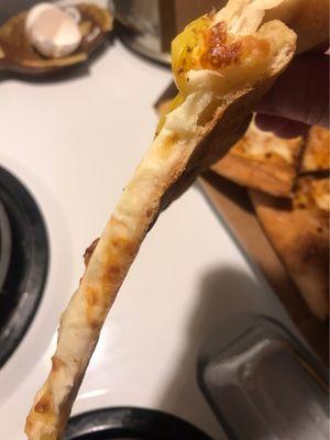 Razor thin hand tossed crust with nothing but cheese over the top.