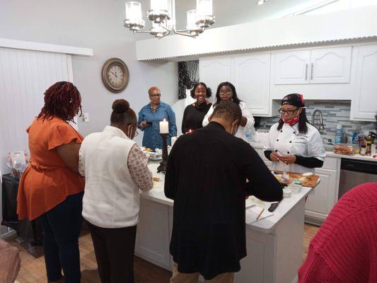 Chef Candace teaching guests cooking basics