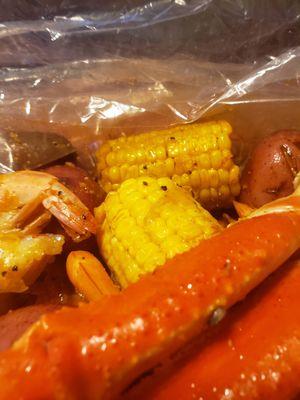 Crab bag with corn, potatoes, and andouille sausage.