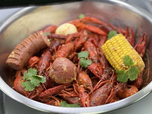 Boiled crawfish with corn, potato, sausage and egg