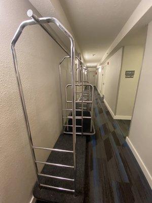 Luggage carts blocking hallway to wheelchair room