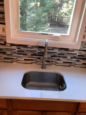 Faucet and backsplash installation