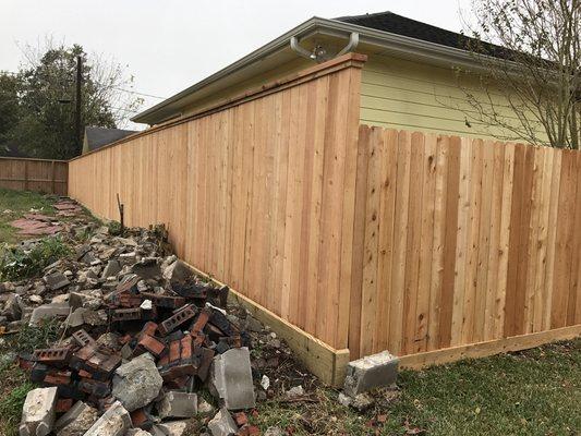 8' high cedar fence cap and trim treated pine rot board