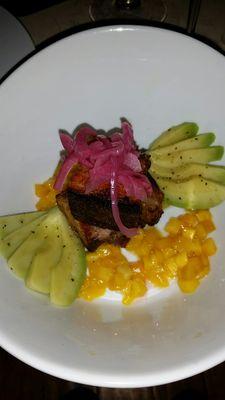 Seared Pork belly tapa with mangos, avocado, and pickled onions