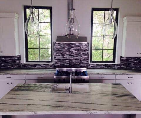 All kitchen counters and island covered in this beautiful off-white marble with gorgeous veining! Very modern!