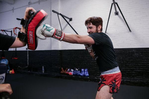 Coach Carlos working on pads