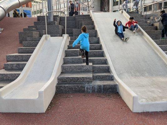 The concrete slides could be a nod to the Brutalist archit of the city hall, but... I am concerned it be brutal for some sliders..