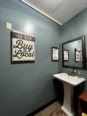 Gender neutral bathroom with fun signs