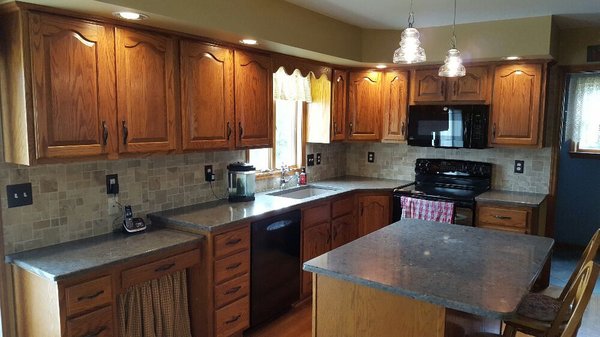 Custom quartz counters and limestone backsplash, new GFCI protected outlets, new island pendant lights