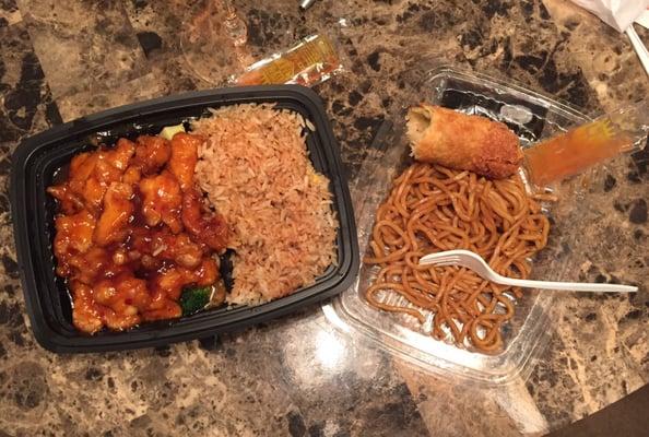 General Tso chicken with fried rice and lo mein with egg roll.