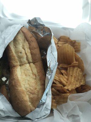 Philly cheesesteak sandwich with chips