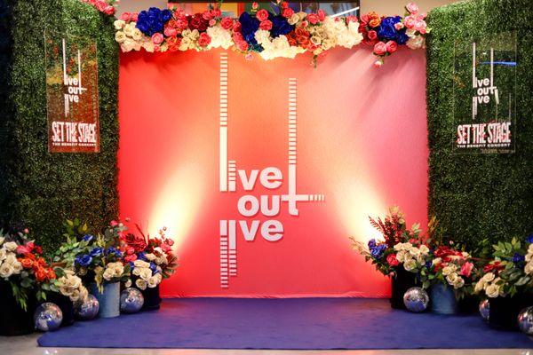 Step and repeat customized for our clients event with festive floral elaborations