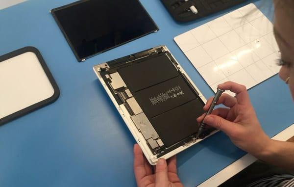 On of our trained technicians repairing a tablet