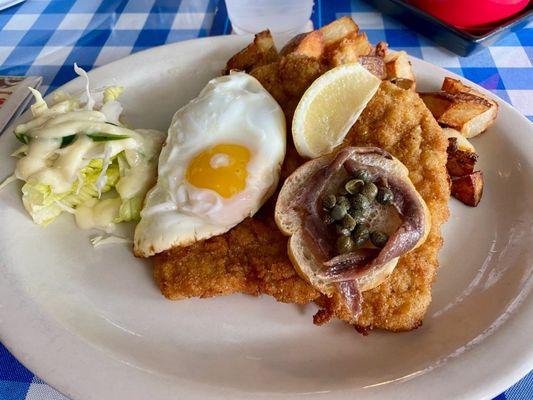 Lunch special: Breaded Pork Schnitzel "Holstein"-Style  (with Egg sunny side up, Anchovis, Capers), and homemade Home fries.