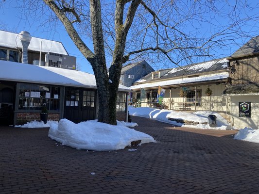 Outdoor courtyard area with the entrance just beyond the tree, around the corner from Earl's.