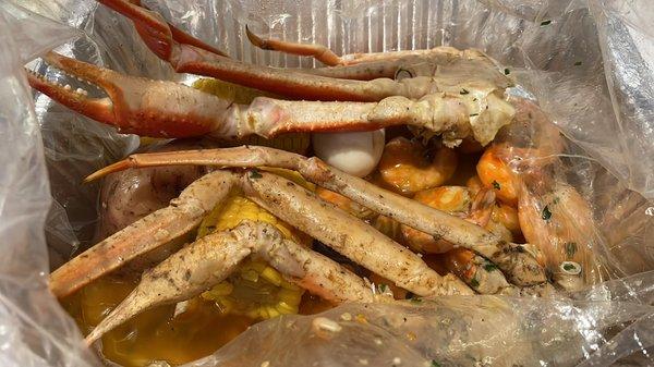 Crab legs, shrimp, corn, and boiled eggs