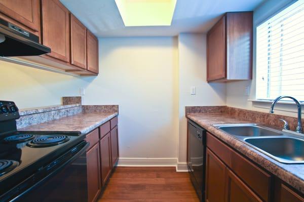 Newly remodeled kitchens feature wood floors, sleek black appliances and resurfaced countertops