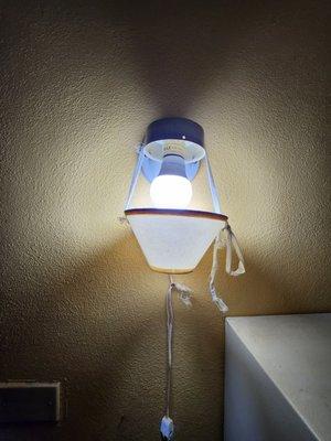 scotch tape and a blouse string holding up this upside down lamp?   most insane electrical work I have seen.  EVER