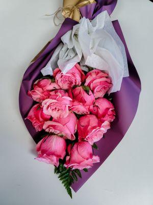 Dozen roses in a beautiful waterproof boutique wrap.