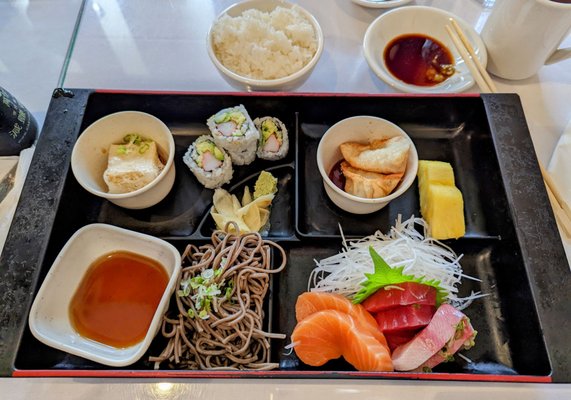 Sashimi Bento (Lunch) comes with fried tofu, gyoza, California roll, and buckwheat noodles