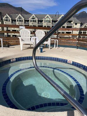 Amazing and deep outdoor hot tub with hotel and mountain views