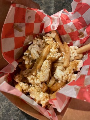 Poutine loaded with cheese curds over crispy fries