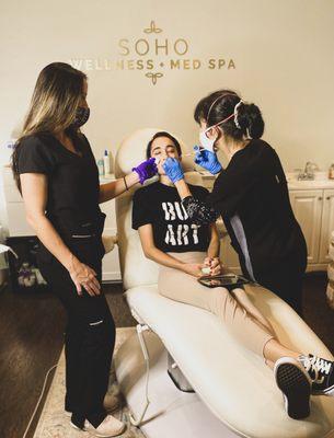 Our team is working together to do filler in the cheek and jawline here at Soho Wellness & Med Spa