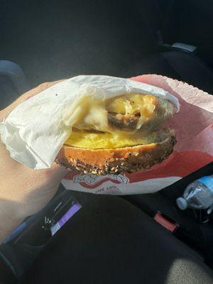 Inedible breakfast sandwich because of Napkin stuck to the bottom of the sandwich.