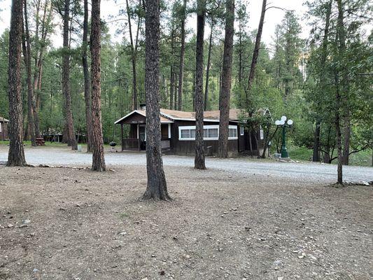 Some trees and green space between each cabin. Cabin Miss Chief in the distance.