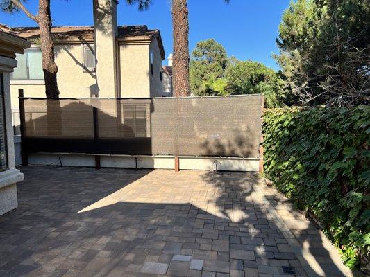 Mesh fence (temporary) with pavers and irrigation.