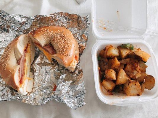 Sesame bagel with Taylor ham, egg, cheese, and ketchup. Side of home fries.