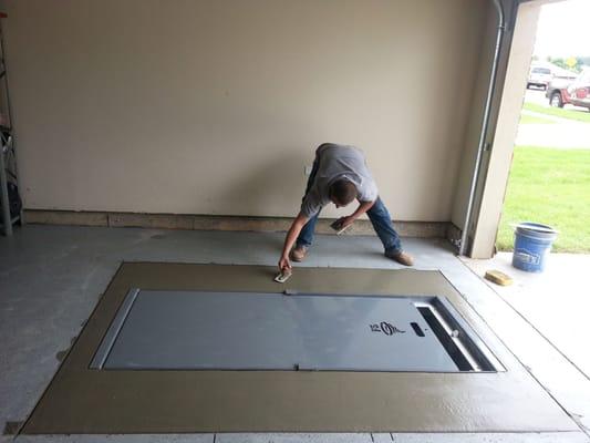 Finishing touches on an underground garage shelter from F5 Storm Shelters of Tulsa.