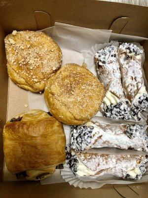 The goods! 1 chocolate croissant, 2 apple filled donuts, 4 cannolis