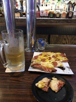 Pizza with pepperoni and banana peppers with a cold budlight to wash it down.