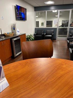 Nice waiting area with a TV and refreshments.