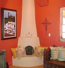 This interior living room got a deep orange to the walls accenting the custom fireplace.