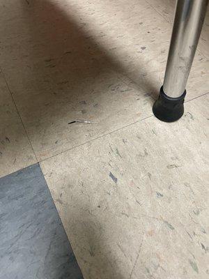 Needle on floor in exam room