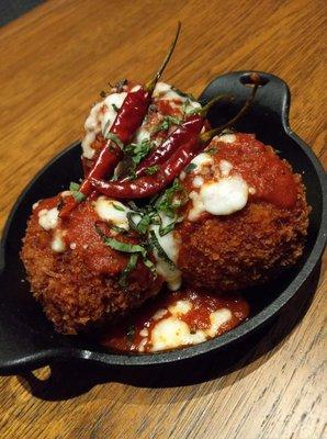 Hand Breaded Lobster mac-n-cheese ball, covered in fresh mozzarella and a spicy tomato Sauce. Garnished with basil and pickled chili's