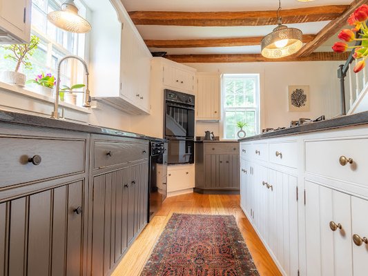 A historic home with freshly sprayed kitchen cabinetry using Farrow & Ball