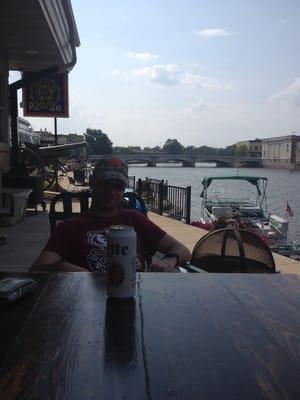 On the patio. Drinking beers and eating burgers.