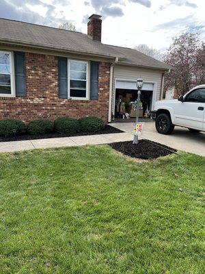 Laid some black mulch, trimmed a few bushes, put down bed edging, and installed a gutter drain due to water problems in the past