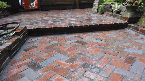 Traditional clay brick patio relay. Herringbone pattern.