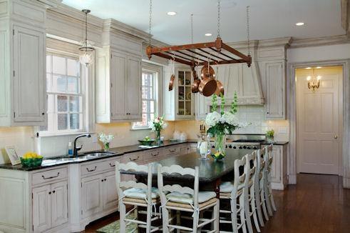 The Kitchen counter and cabinets have painted raised panels with granite countertops and tile backsplash.